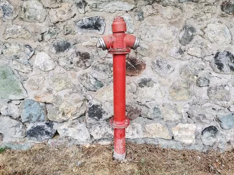 Fire hydrant in front of the wall. Stock Photos