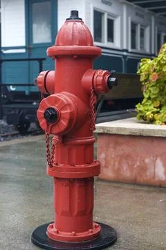 Fire Hydrant Installed on Wet Urban City Street Stock Photos