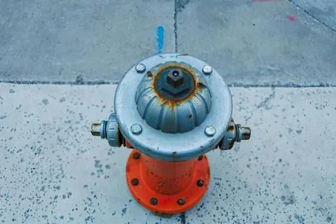 Fire hydrant on sidewalk in urban street scene Stock Photos
