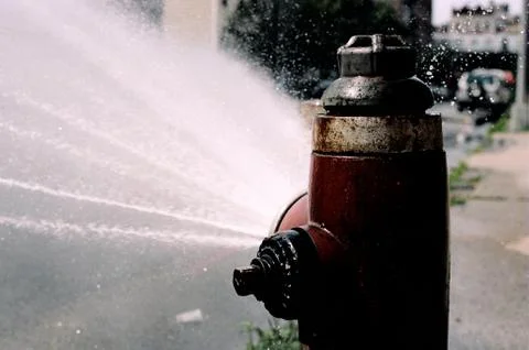 Fire Hydrant spraying water Stock Photos