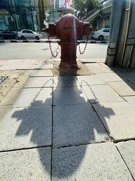 Fire Hydrant in street with shadow Stock Photos