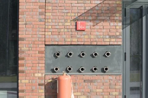 Fire hydrant water emergency system for office buildings in a brick wall. Stock Photos