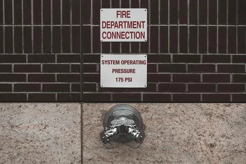 Fire hydrant water pipe, mounted in a building wall. Manhattan USA Stock Photos