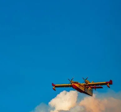 Fire hydroplane over the clouds with clear sky Foto stock