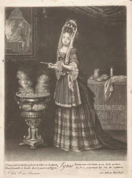 Fire; Ignis; The four elements. The element fire. A young lady bakes poffe... Stock Photos