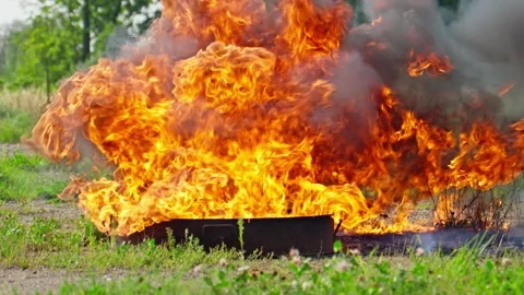Fire ignites in blaze of vibrant orange flames, creating thick black smoke. Stock Footage 284608209