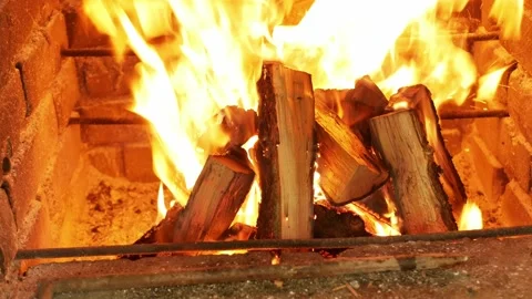 Fire, igniting a fire. Flames in the fireplace, wood for cooking meat. Brick Video stock 156599013