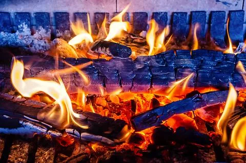 Fire inside a fireplace Stock Photos
