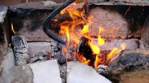 Fire Iron in Orange Bonfire with Red Coals. Video stock 133084264
