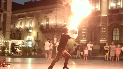 Fire juggler performs night show in Catania Sicily among tourists Stock Footage 206176363