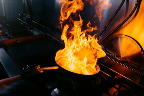 Fire in the kitchen. fire in the pan. Stock Photos