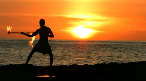 Fire knife dancer performs at sunset Stockbeeldmateriaal 62280880