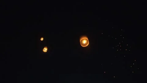 Fire Lanterns Floating up into the sky at night at Loi Krathong Festival Trav Stock Footage 195971049