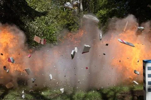 Fire from a large explosion between green trees The moment of explosion. F... 写真素材