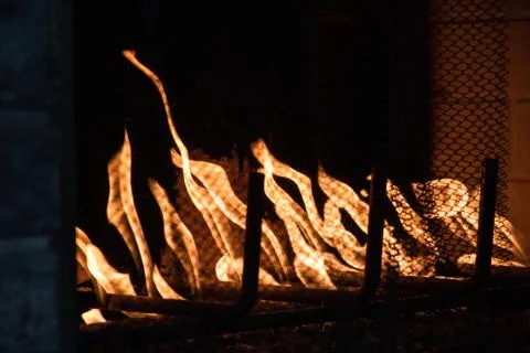 The fire. Large orange fire in the fireplace with a stone dark background Stock Photos