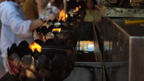  Fire light in oil lamp in the temple. People refueling in lamps. Stock Footage 123476495