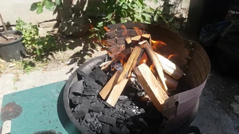 Fire lit for a barbecue grill Stock Footage 136541140