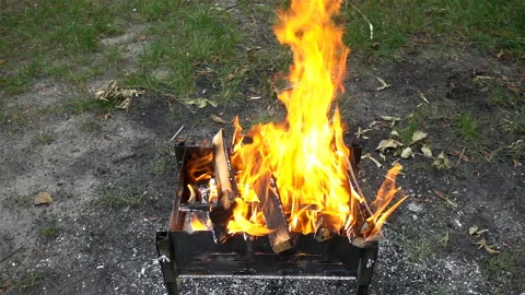 Fire from logs burning in Slow Motion on a metal barbecue Stock Footage 118500167