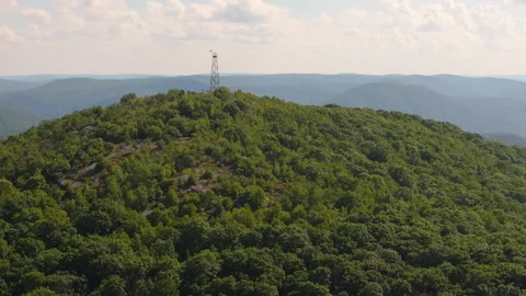 Fire lookout tower fly by on Mount Beacon in New York Stock Footage 346408700