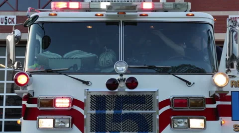 Fire men testing fire engine with lights on at the fire department Stock Footage 66548750