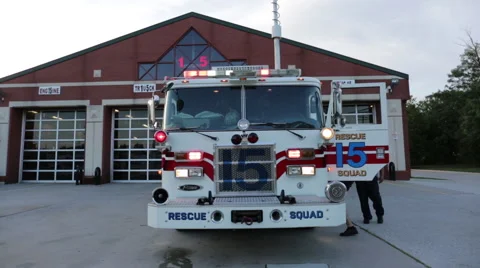 Fire men testing fire engine with lights on at the fire department Stock Footage 66548826