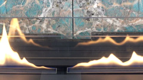 Fire of a modern fireplace and wall with blue tiles Video stock 135323550