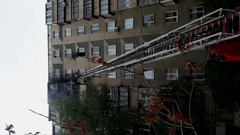 Fire in a multi-storey building, firefighters extinguish the fire on the ba.. Stock Footage 256578102