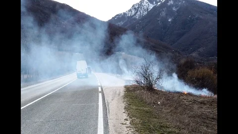 Fire near road, slow motion Stock Footage 104292939