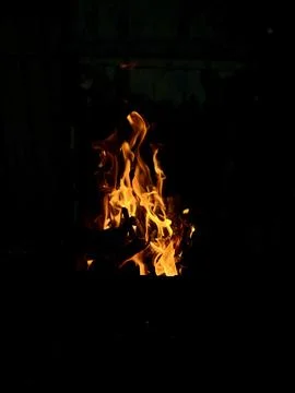 A fire on night black background, vertical photo Stock Photos