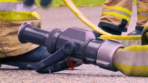 Fire Nozzle with hand picking up in Slow-mo Video stock 143880449