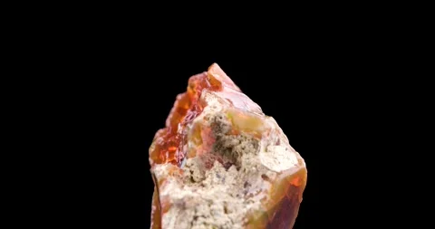 Fire opal crystal 360° rotation in 4k isolated on black background Stock Footage 257306816