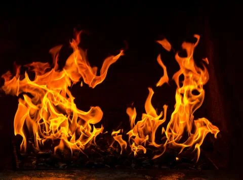 Fire in a oven, two flames on the black background Stock Photos