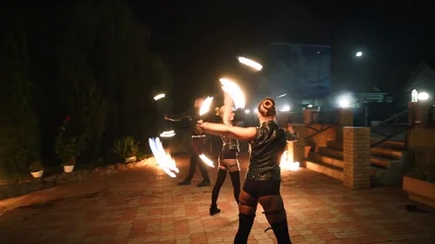 Fire performance show. Artists spin burning poles at night. Outdoor tribal dance Stock Footage 252771995