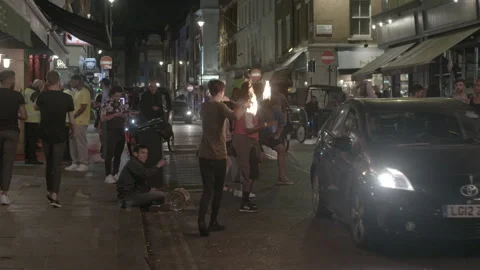 Fire Performer Dancing on Night Street in Soho Stock Footage 344622632