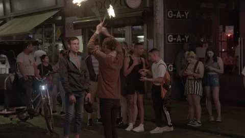 Fire Performer Entertaining Nightlife Crowd on Street Stock Footage 344623929