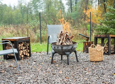 Fire pit and burning fire in a garden Stock Photos