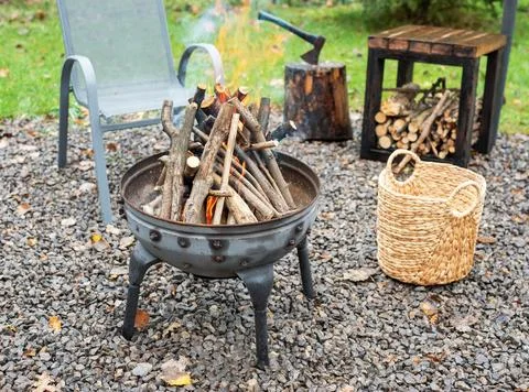 Fire pit and burning fire in a garden Stock Photos