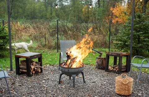 Fire pit and burning fire in a garden Stock Photos