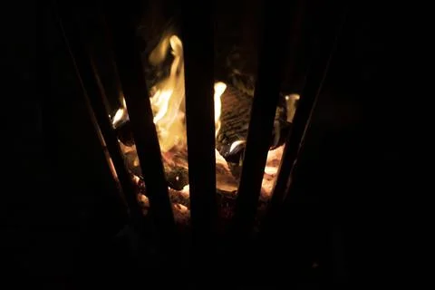 Fire pit with beautiful fire flames to warm up and cook in the night. Stock Photos