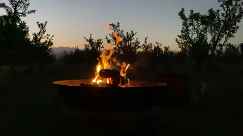 Fire pit in a calm mountain landscape at beautiful sunset Stock Footage 256906375