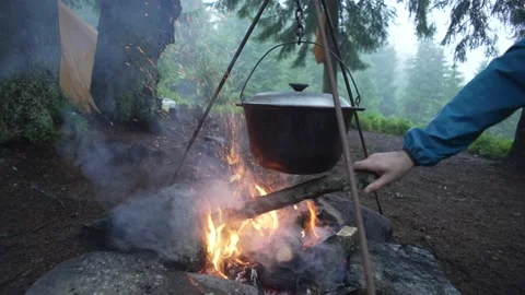 Fire pit hiking. Cooking in the forest in the rain. A cauldron on a fire Stock Footage 214328074