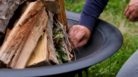 Fire Pit Ignited with a Match by Man Near Country House Preparing Outdoor Wood Stock Footage 344814100