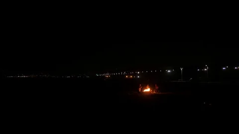 Fire pit at night at the beach with highway in the backround. Stock Footage 83117571