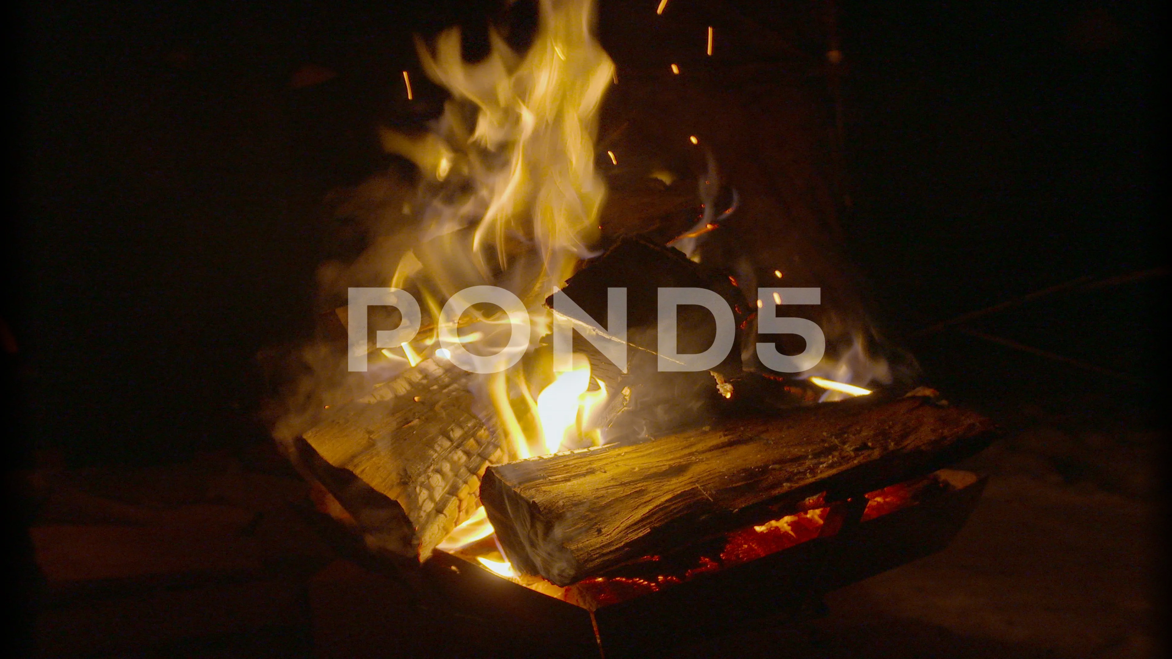 Fire Pit At Night Sparks Go Flying Out 78646424