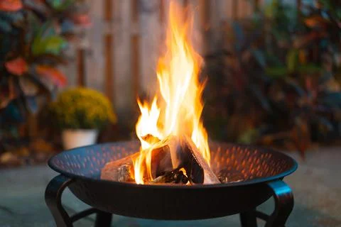 Fire pit. Outdoor fire pit with red flame. Evening gatherings by the fire Stock Photos