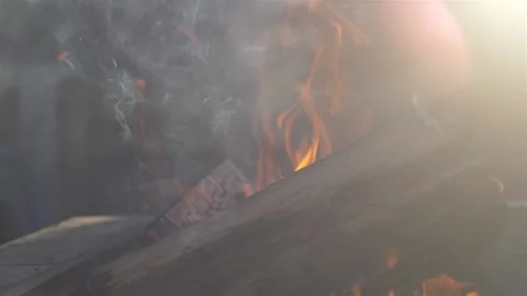 Fire pit slow motion close up with sun flare on side Stock Footage 236596600