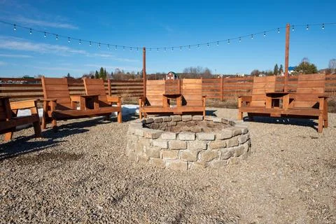 A fire pit with a string of lights hanging from the top. Stock Photos