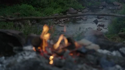 Fire place in front of the flowing river Stock Footage 236705148