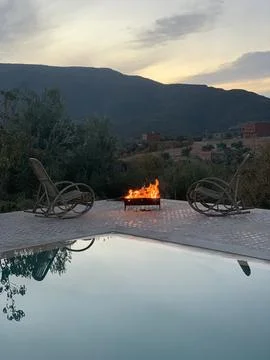 Fire by the pool on the countryside with mountains Stock Photos
