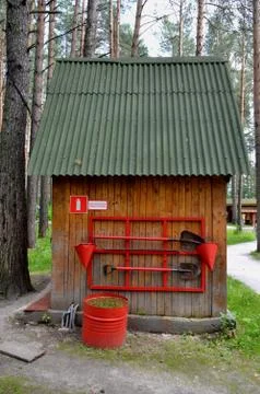 Fire-prevention shield with the tool to extinguish the fire Stock Photos